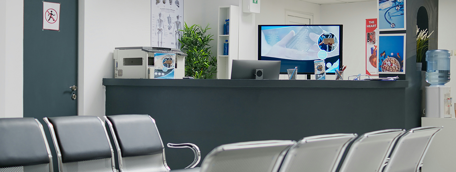 doctor office waiting room with chairs and desk