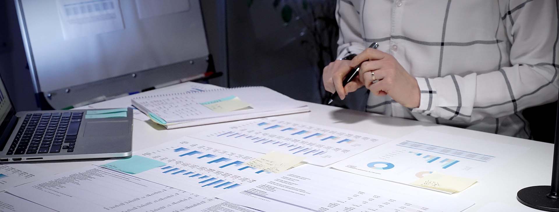 businessperson examining financial reports and charts