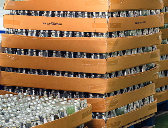 Bottled juice beverage stacked in carton packaging at warehouse