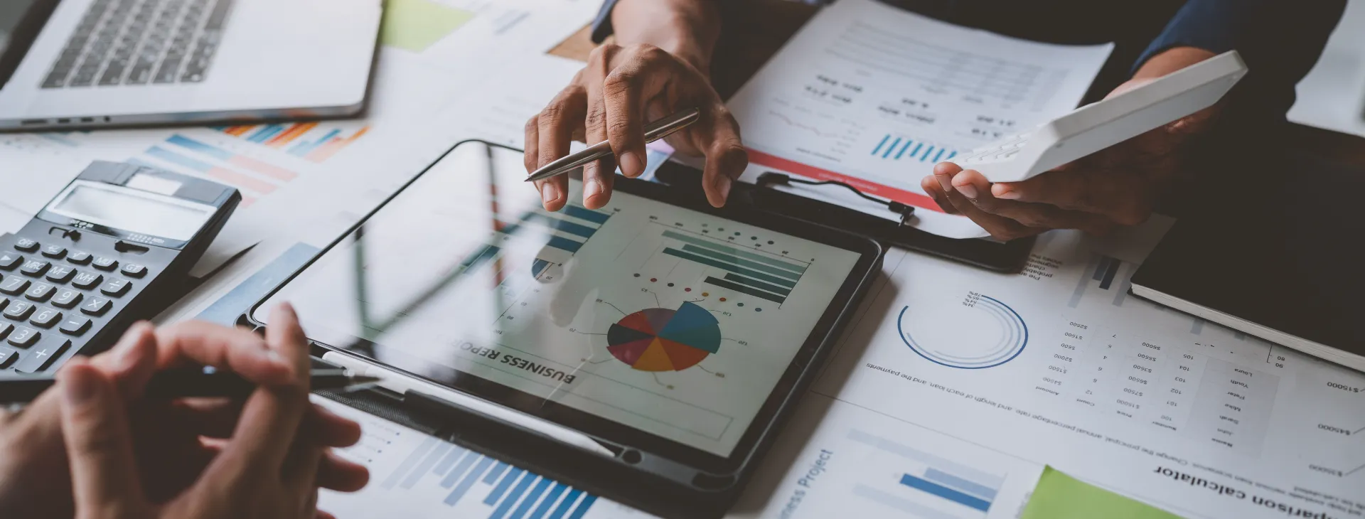 business people reviewing charts and graphs showing the growth of investment results
