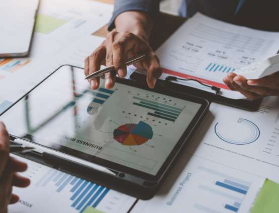 business people reviewing charts and graphs showing the growth of investment results