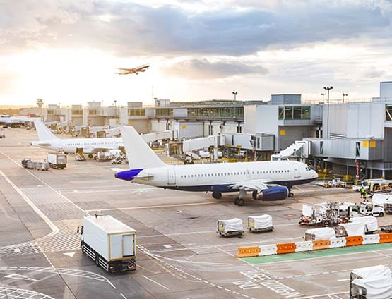 airport view with airplanes and service vehicles