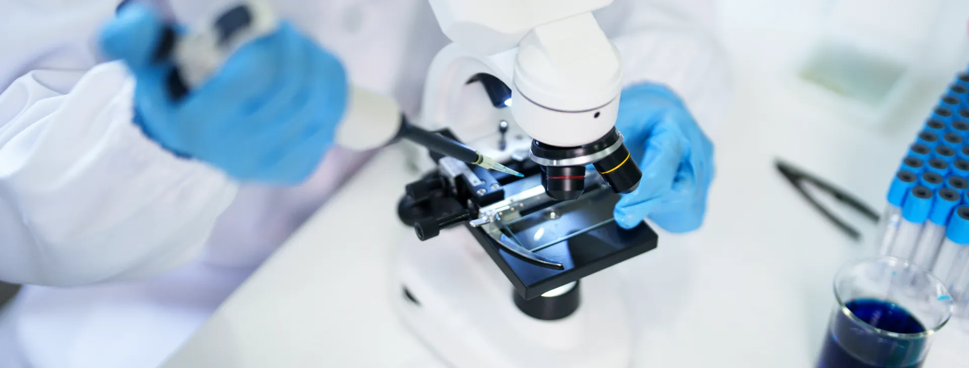 scientist using a microscope in a laboratory