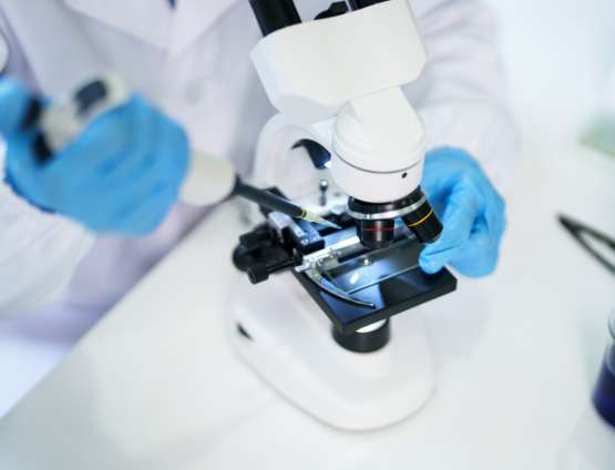 scientist using a microscope in a laboratory