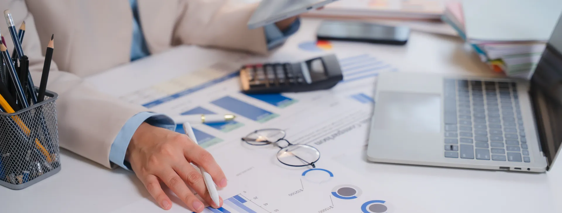 a businessperson reviewing financial reports and charts