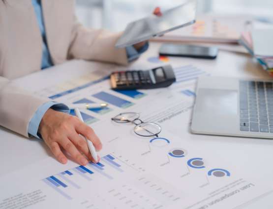 a businessperson reviewing financial reports and charts