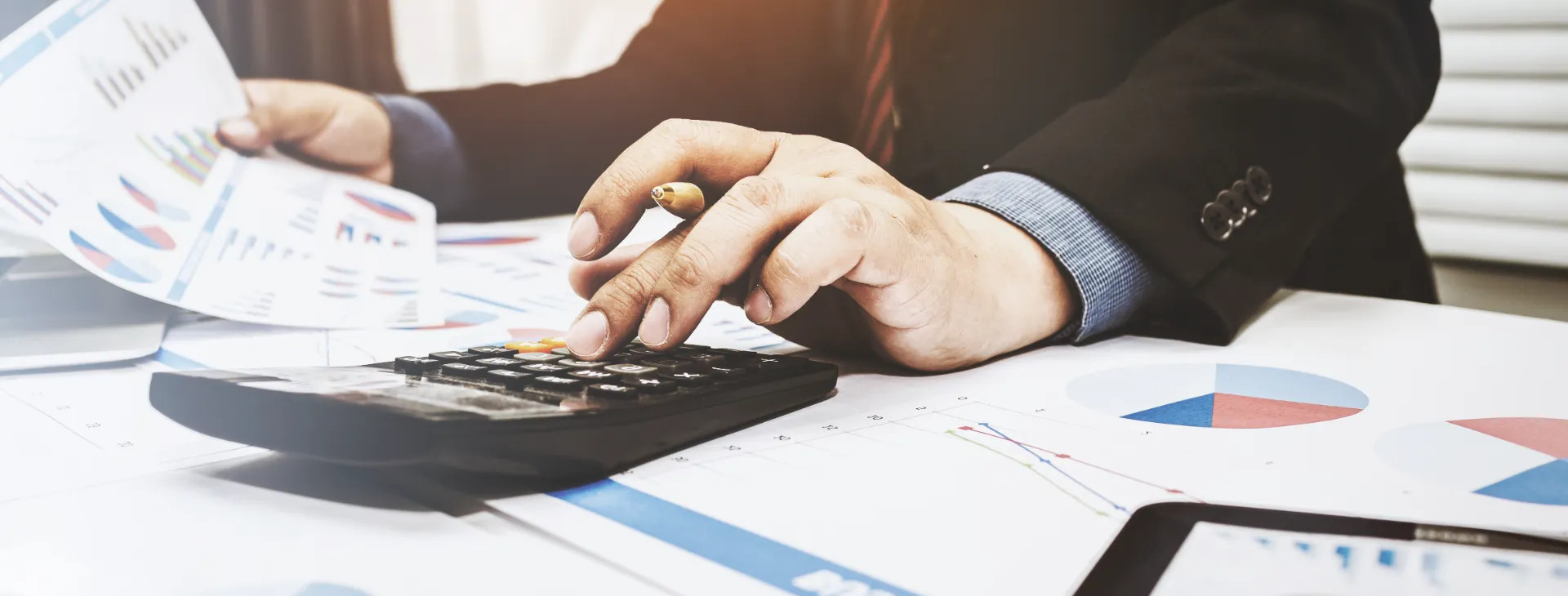 businessman using a calculator and working on financial reports