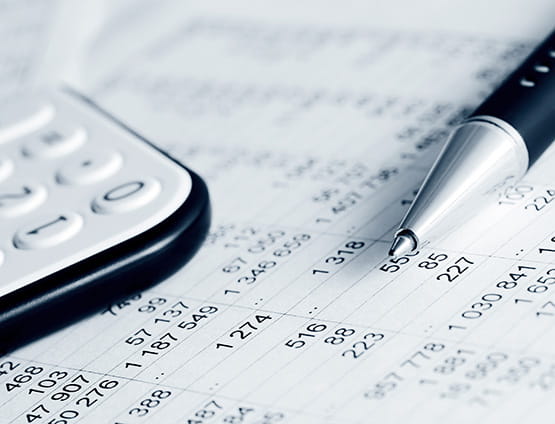 financial report with a calculator and pen