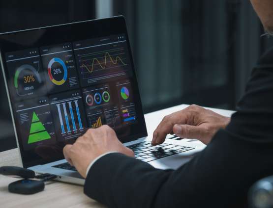 businessman analyzing a complex financial data infographic on a laptop screen
