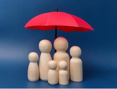 umbrella protecting wooden figures
