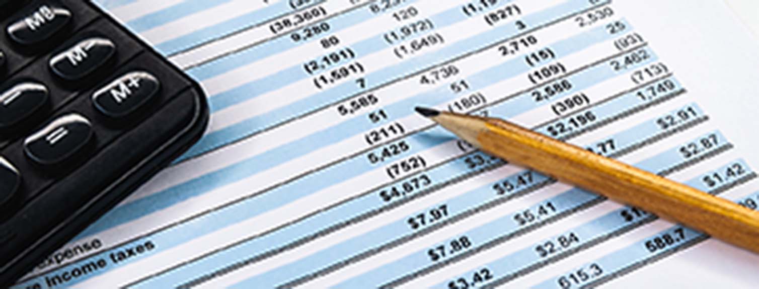 calculator sitting on profit & loss statement