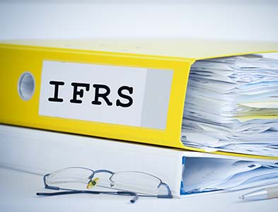yellow binder labeled IFRS full of paperwork