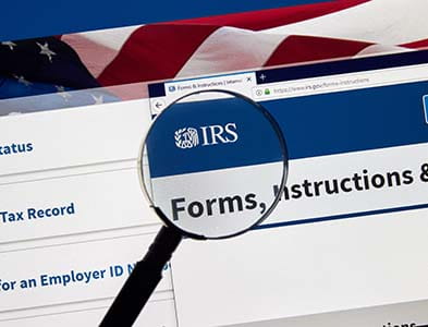 IRS website on computer and magnifying glass