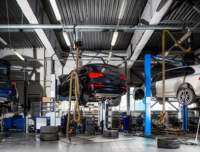 car on lift in auto shop for repair