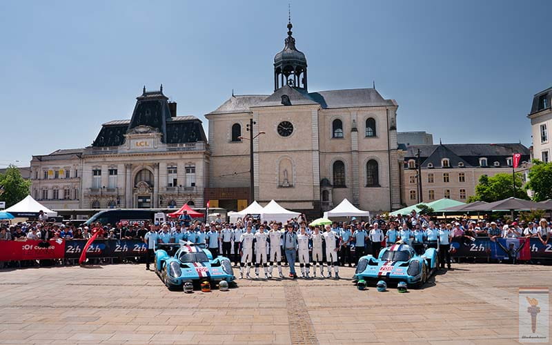 Car Racing team standing in front of building