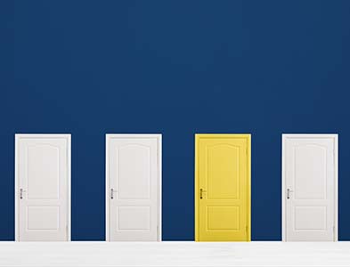 Image of one yellow door among other white doors