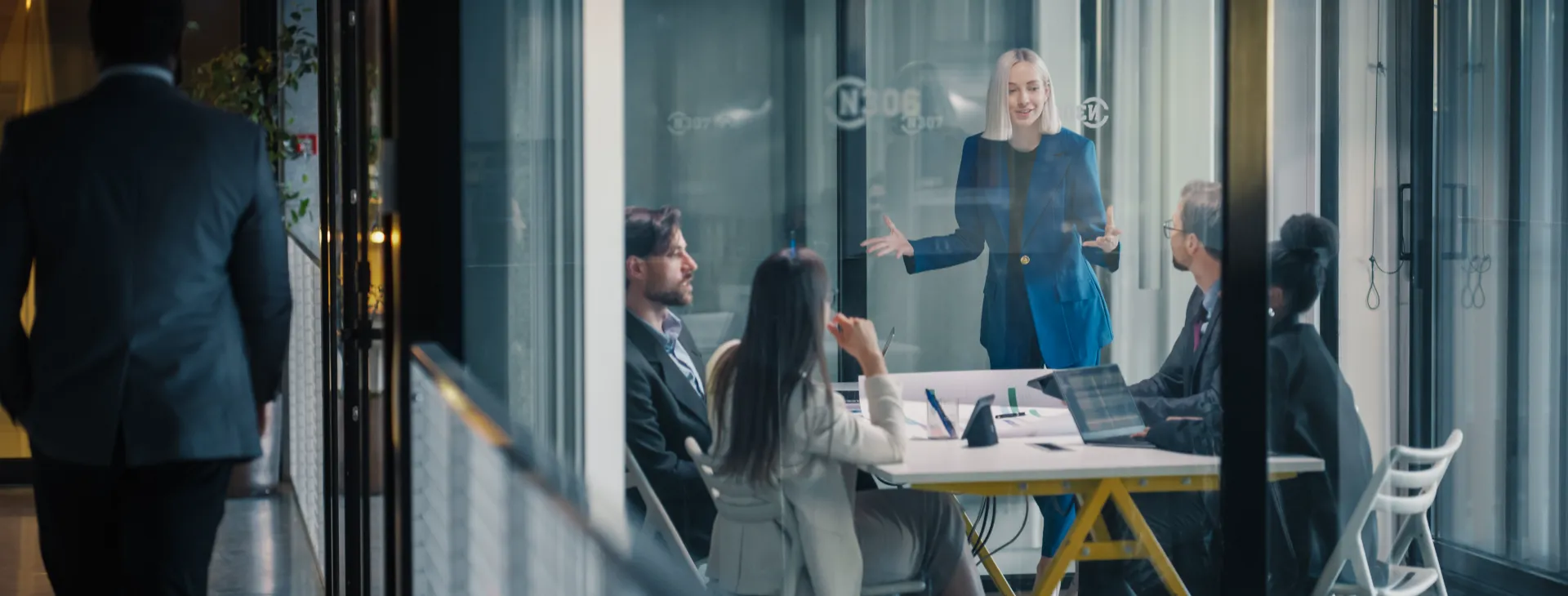 Businesswoman Leads a Strategic Planning Meeting in a Glass Conference Room